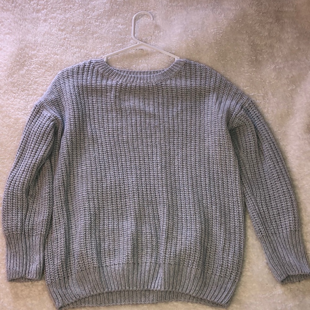 Light blue/grey sweater.